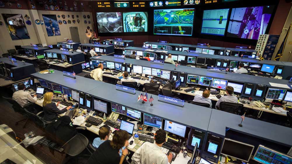 Mission control room with multiple screens, representing the perceived complexity of personal reputation management